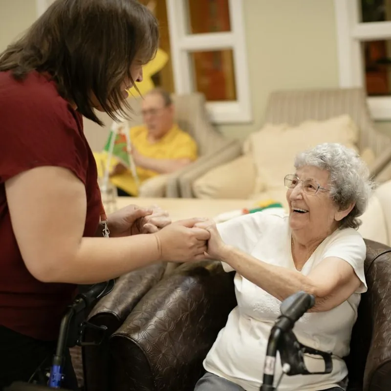 A trained nurse caring for an elderly woman at home